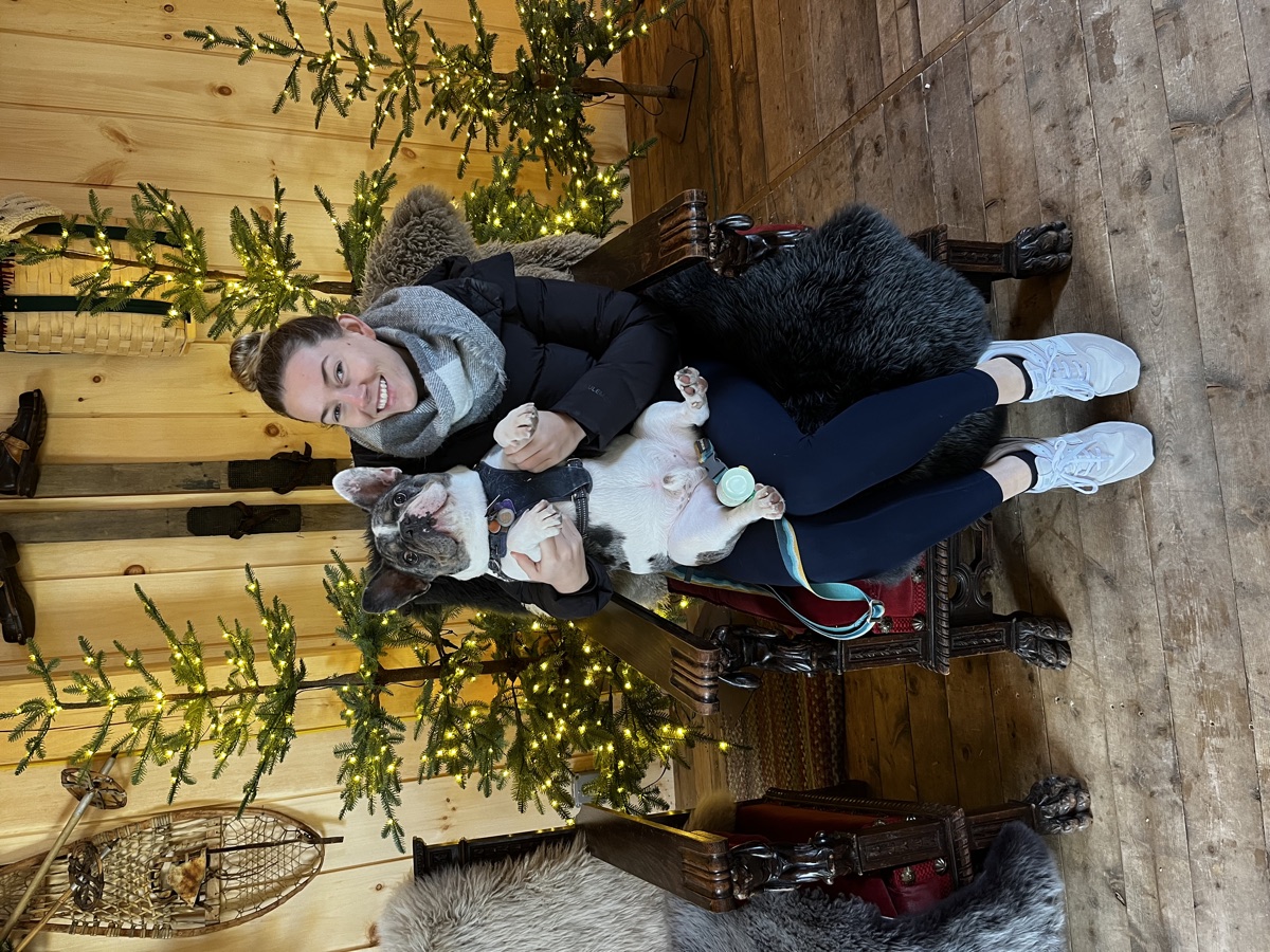 Louie held in a cabin hung with lit trees